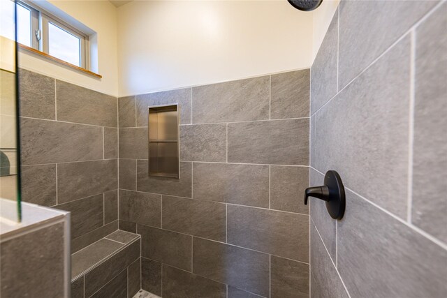 bathroom with a tile shower