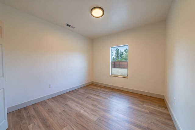 unfurnished room with wood-type flooring