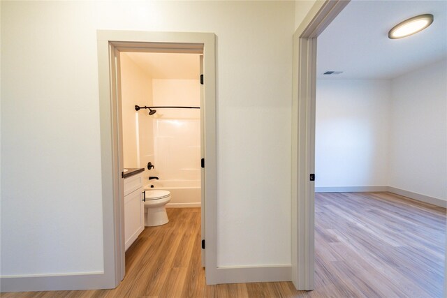 full bathroom with vanity, toilet, bathtub / shower combination, and wood-type flooring