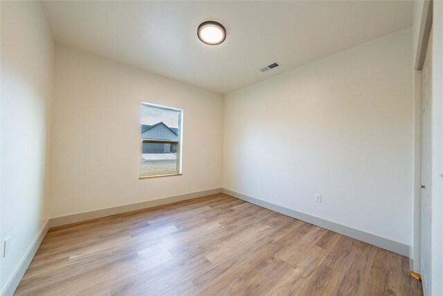 spare room with light hardwood / wood-style flooring