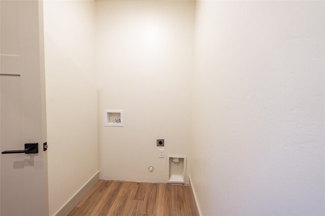 laundry area featuring hookup for a gas dryer, hookup for a washing machine, electric dryer hookup, and light hardwood / wood-style flooring