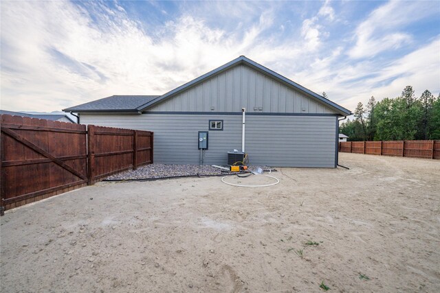 rear view of property with cooling unit