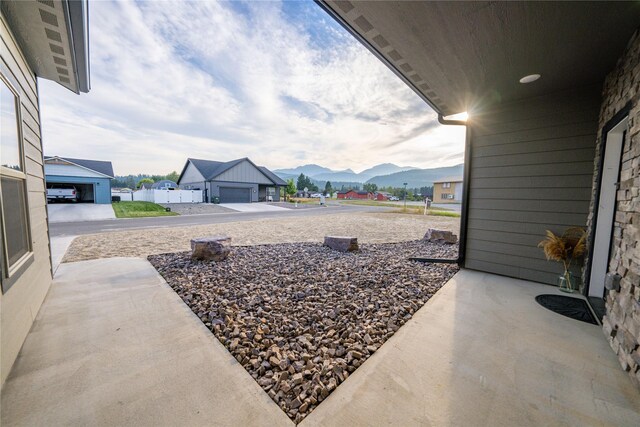 view of patio / terrace with a mountain view and a garage