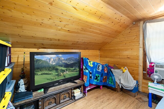 interior space with lofted ceiling, light wood-type flooring, wooden walls, and wooden ceiling