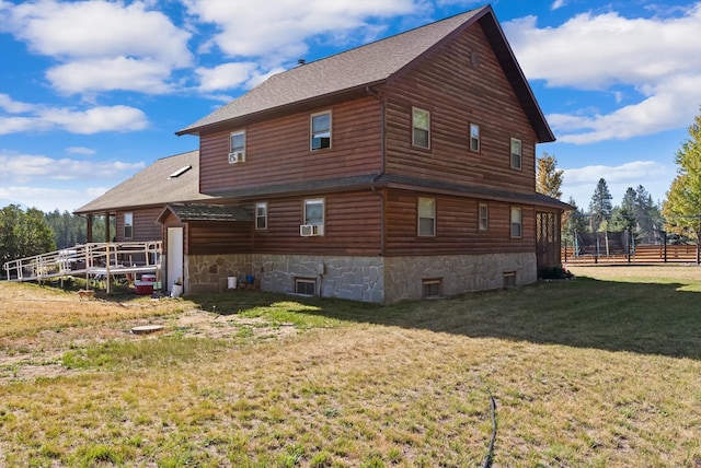 back of property featuring a lawn