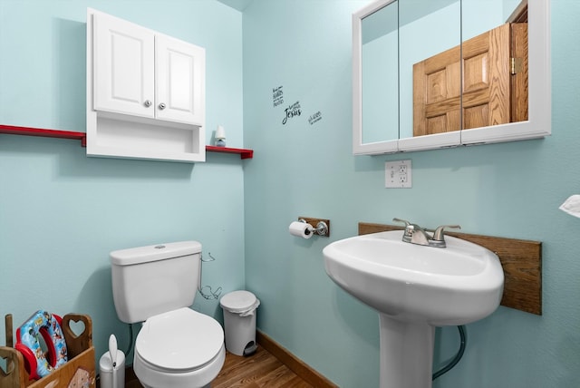 bathroom featuring hardwood / wood-style floors and toilet