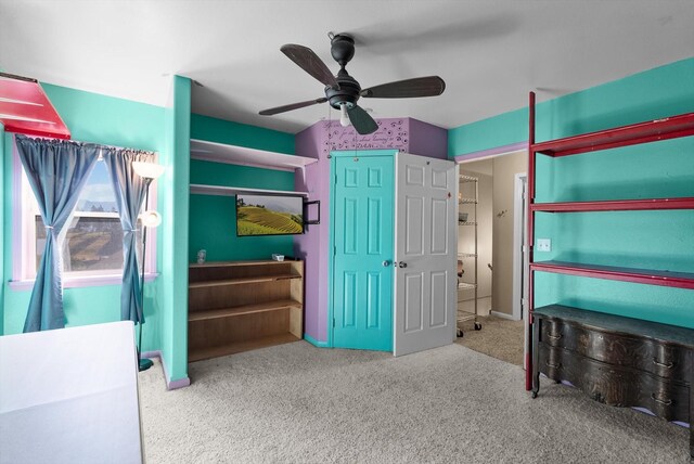 unfurnished bedroom with ceiling fan and light colored carpet