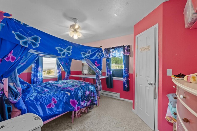 bedroom with a baseboard heating unit, ceiling fan, and light colored carpet