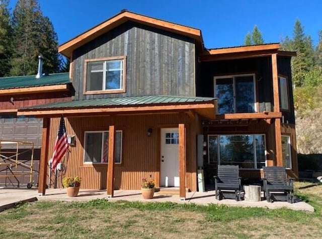 4 Lake Dr, Heron, MT 59844 - view of front of house featuring a front lawn, metal roof, and an attached garage