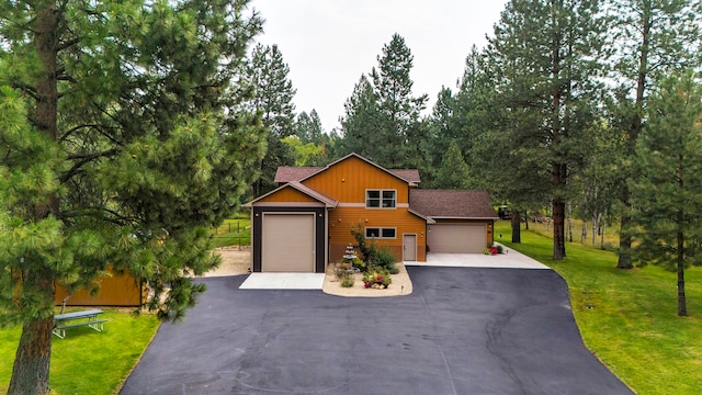 view of front of home with a front lawn and a garage