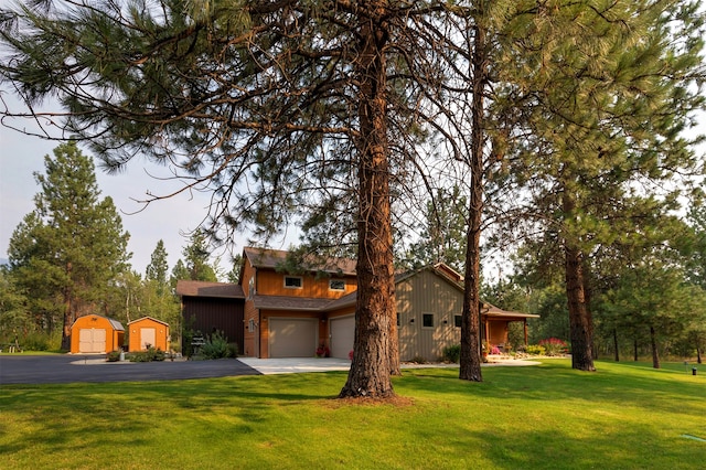 view of front of home with a front yard and a garage