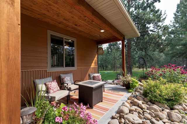 view of patio featuring an outdoor living space with a fire pit