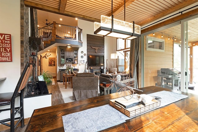 dining area featuring stairs and beamed ceiling