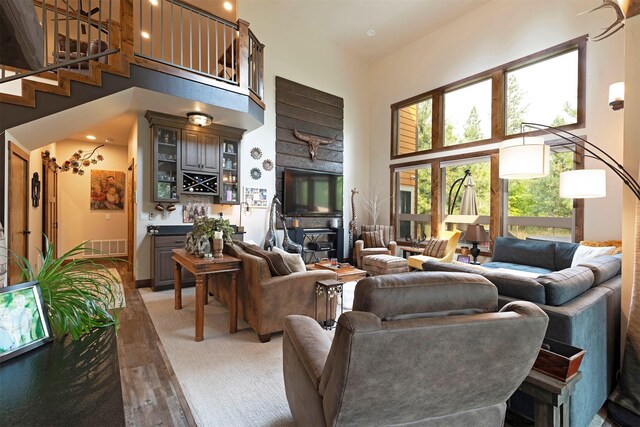 living room featuring a high ceiling and hardwood / wood-style floors