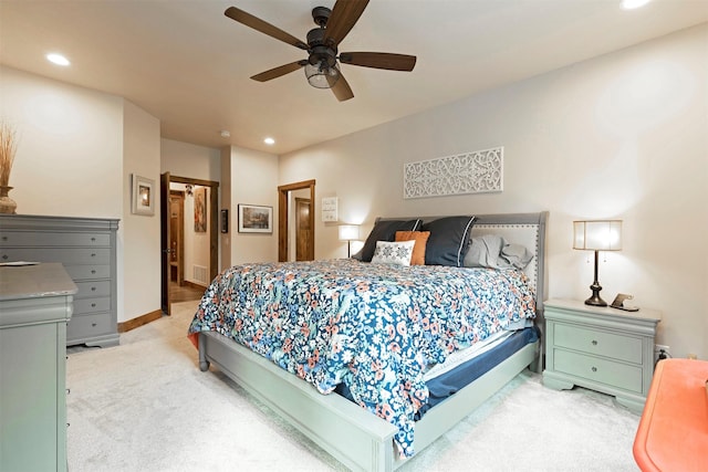 bedroom featuring recessed lighting, light colored carpet, ceiling fan, and baseboards