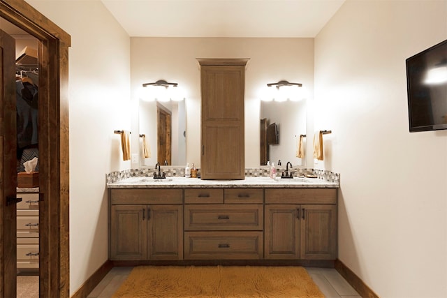 bathroom featuring tile patterned floors and dual vanity