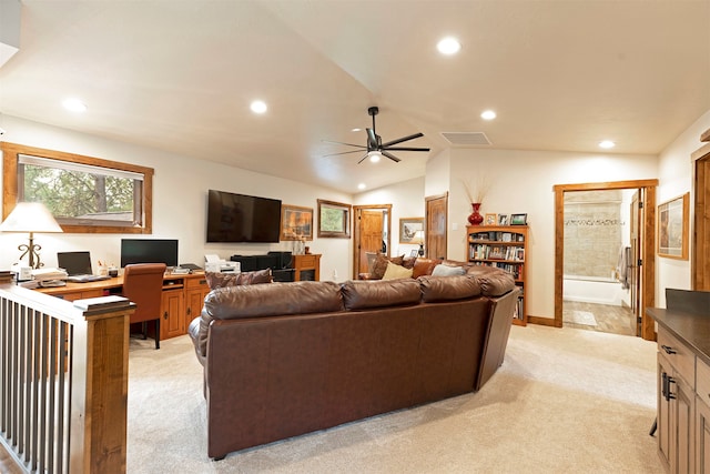 living room with ceiling fan, lofted ceiling, and light carpet