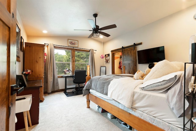 bedroom with light carpet, a barn door, lofted ceiling, ceiling fan, and recessed lighting