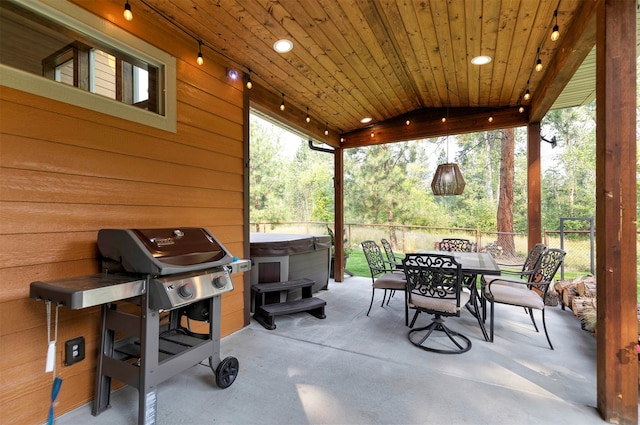 view of patio / terrace with grilling area and a hot tub