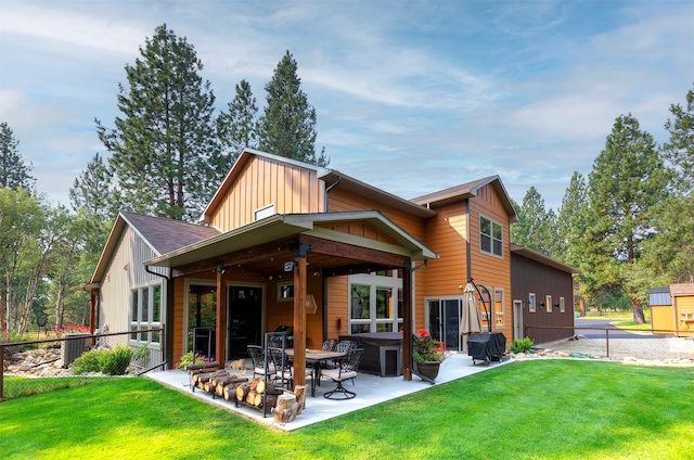 back of property featuring a patio area, fence, board and batten siding, and a yard