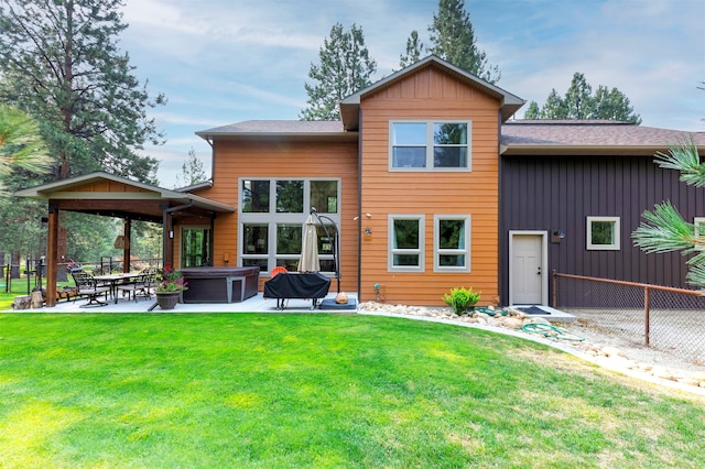 rear view of house featuring a lawn and a patio area