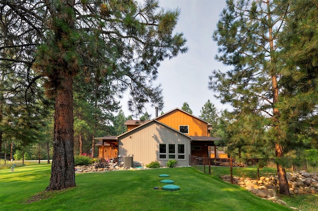 rear view of house with a lawn