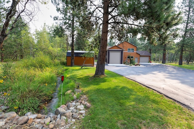 view of front of house featuring a garage and a front lawn