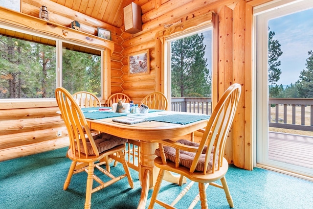 carpeted dining room with log walls