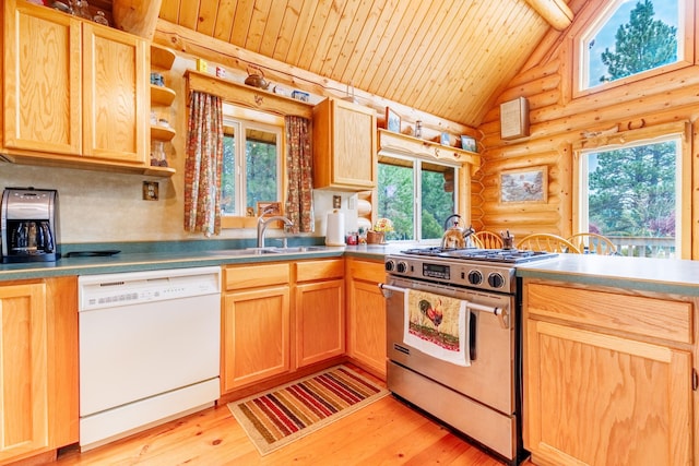kitchen with rustic walls, light brown cabinets, a sink, white dishwasher, and gas stove