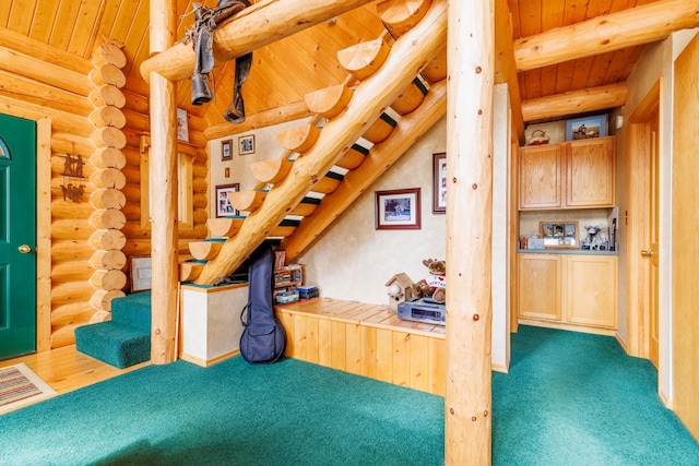 office space featuring rustic walls, carpet floors, wood ceiling, and beamed ceiling