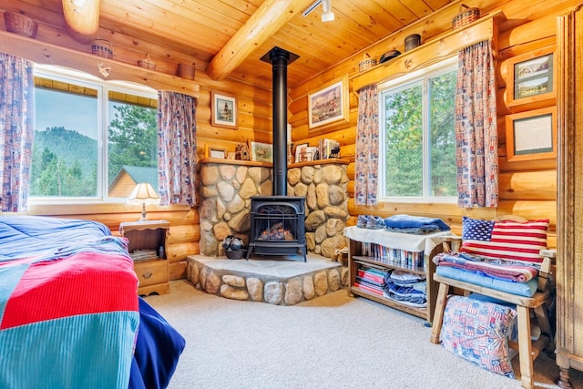 bedroom with carpet flooring, beam ceiling, rustic walls, wooden ceiling, and a wood stove
