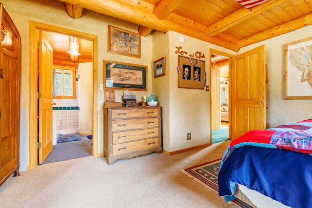 bedroom featuring beam ceiling, ensuite bathroom, wood ceiling, and carpet floors