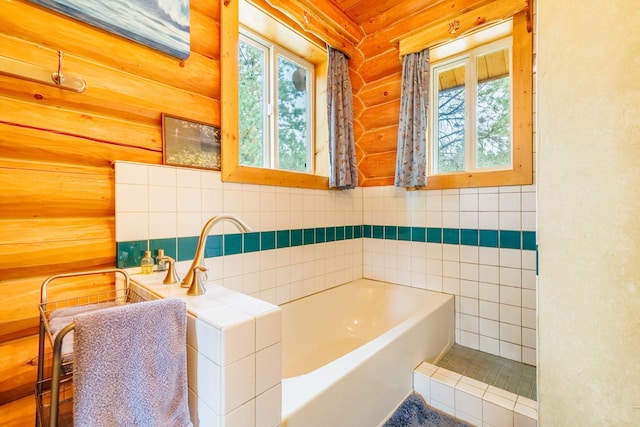 bathroom with a garden tub and rustic walls