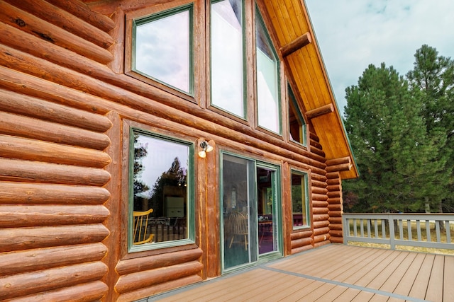 view of home's exterior featuring log siding and a deck