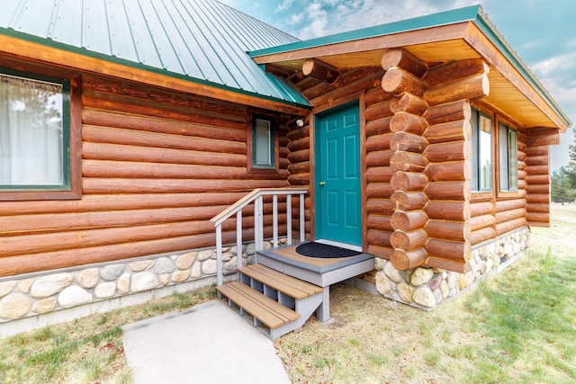 property entrance with log siding and metal roof