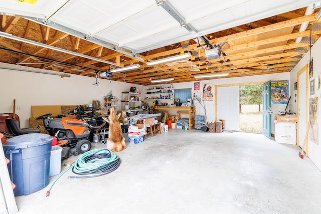 garage with a garage door opener and a workshop area