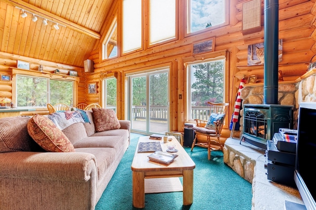 living area featuring rustic walls, carpet floors, a wood stove, and high vaulted ceiling