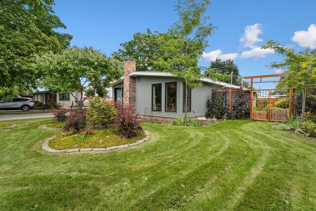 view of side of home featuring a lawn