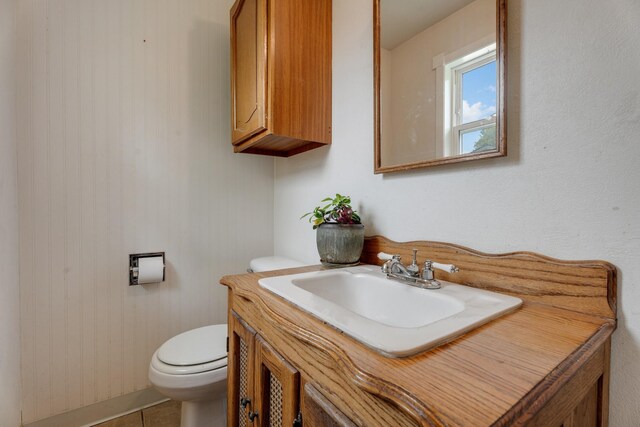 bathroom with vanity, toilet, and tile patterned flooring