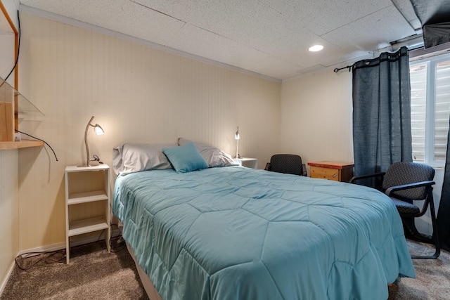 bedroom featuring ornamental molding and carpet