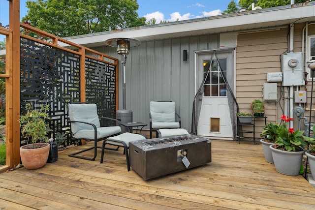 wooden terrace with a fire pit