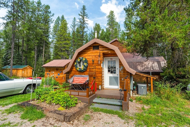 view of front of property with cooling unit and a storage unit