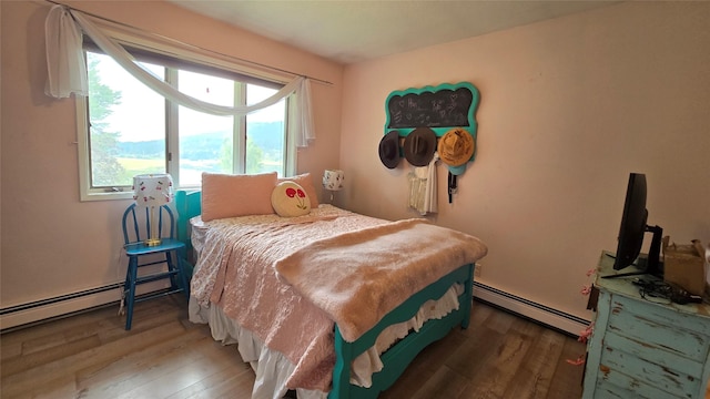 202 Lakeshore Dr, Kalispell, MT 59901 - bedroom with a baseboard heating unit and wood finished floors
