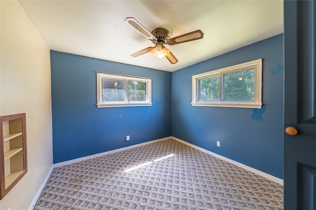 carpeted empty room with ceiling fan