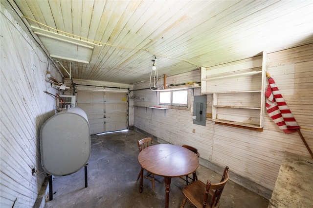 garage with wooden walls and electric panel