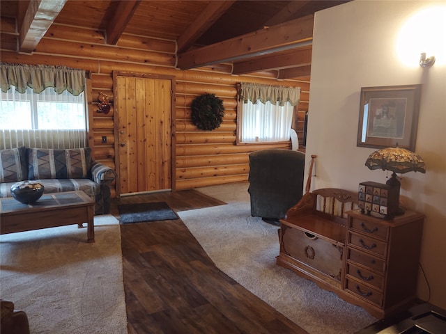 living room with wood ceiling, log walls, and vaulted ceiling with beams