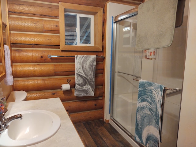 bathroom featuring vanity, toilet, hardwood / wood-style floors, and an enclosed shower