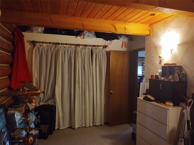 bedroom featuring wooden ceiling and carpet