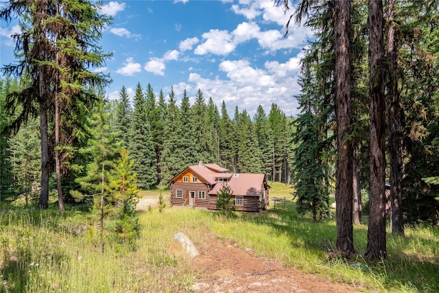 birds eye view of property featuring a wooded view