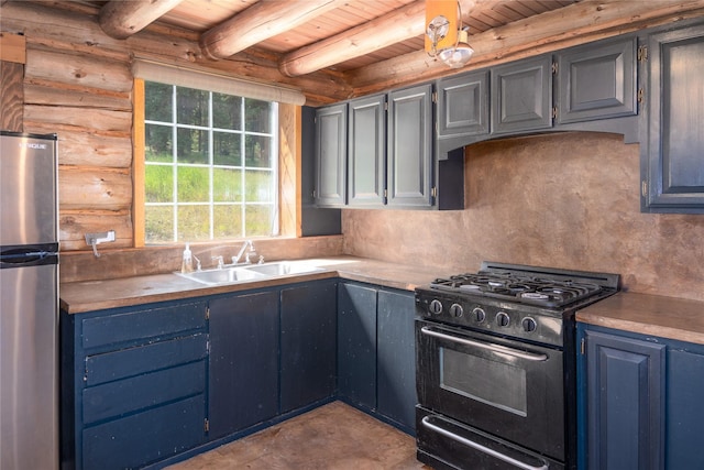 kitchen with tasteful backsplash, black gas range oven, freestanding refrigerator, a sink, and beamed ceiling